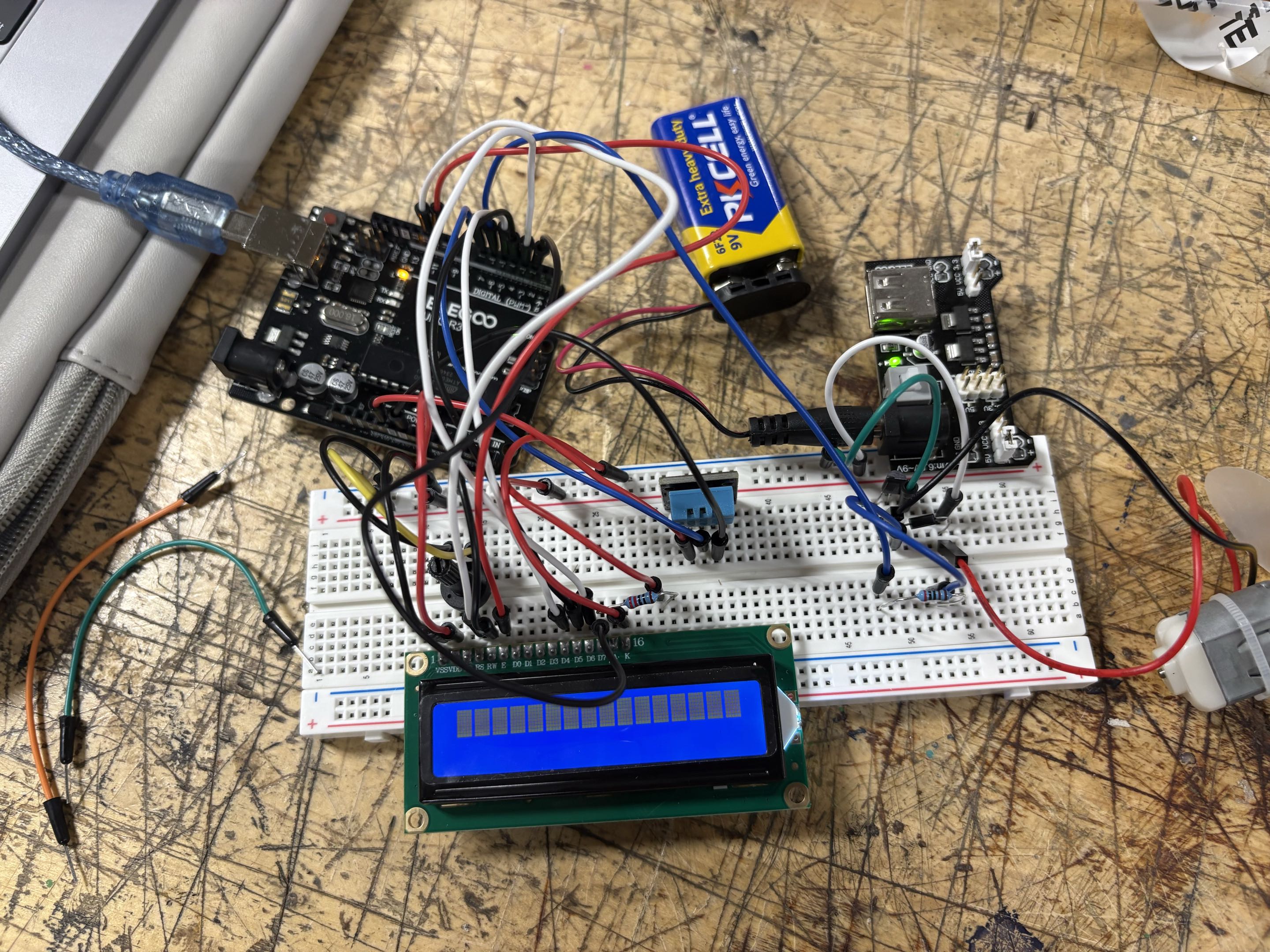 Arduino breadboard wiring for temperature-controlled fan showing sensor and display connections