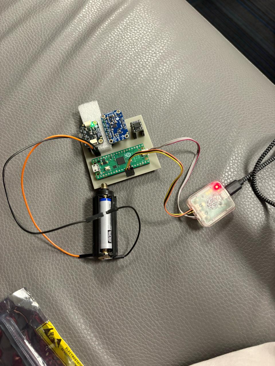 Rocket payload board with sensors mounted, photographed during final pre-launch programming session